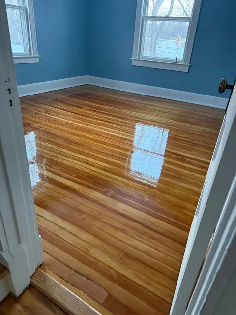 Blue bedroom with a refinished pine floor, glossy finish
