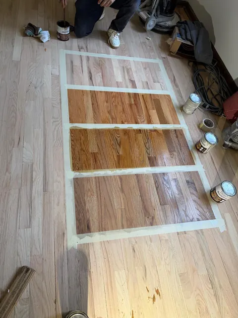 Real stain samples taped out on a sanded oak floor