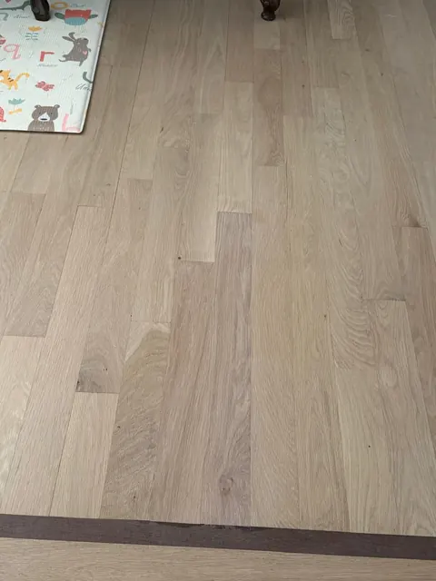 Newly installed white oak plank floor before finishing