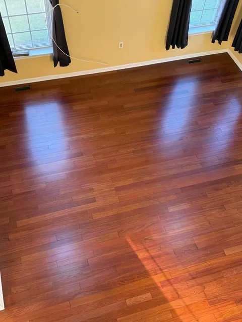 Hardwood floor stained a deep red-brown color, glossy finish