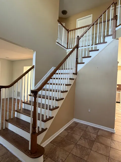 Staircase with refinished oak treads and rails, white spindles