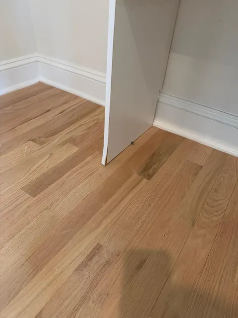 Natural white oak floor, matte finish, at a corner wall