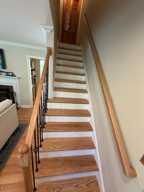 Oak staircase with iron balusters, seen from the living room