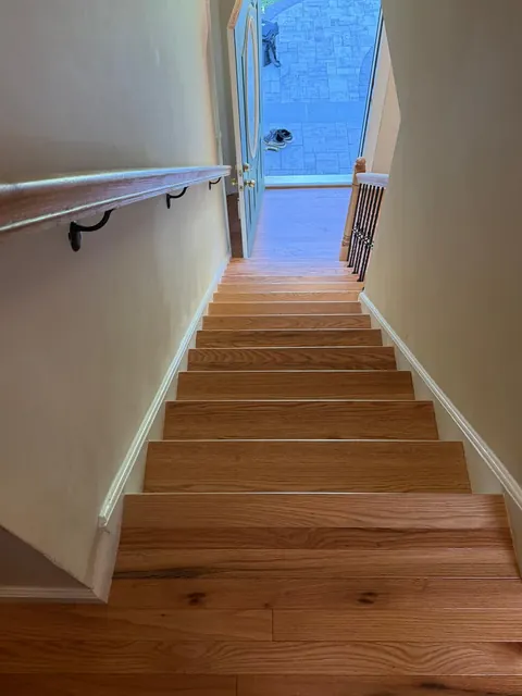 Looking down a staircase with wide-plank oak treads