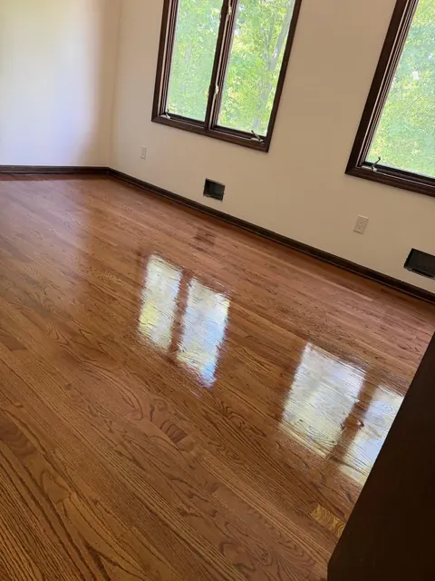 Room with dark window trim and a deep brown stained oak floor