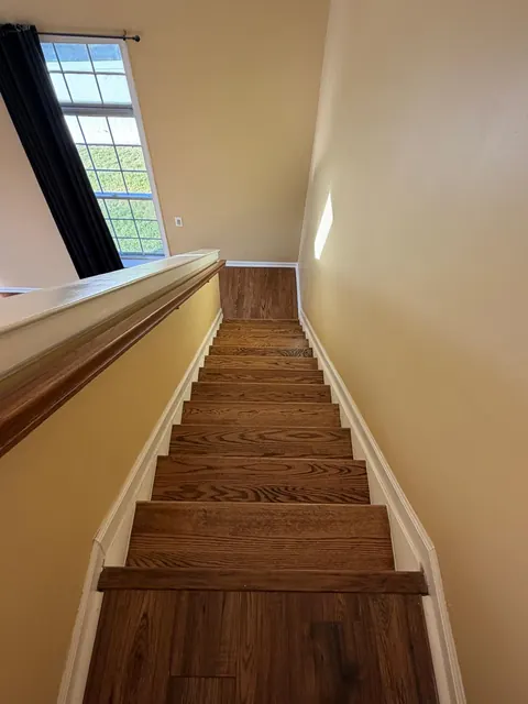 Refinished oak staircase leading up to a landing