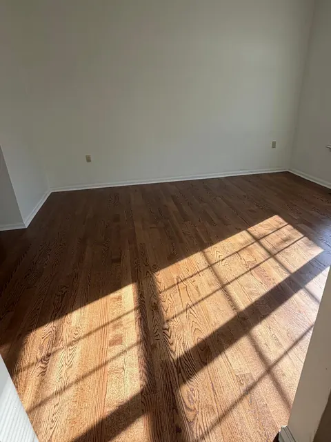 Sunlight across a refinished oak floor with a brown stain