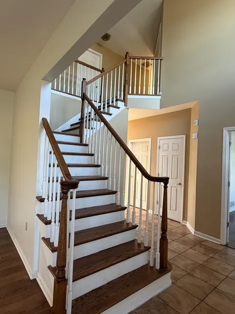 L-shaped staircase with refinished oak treads and white balusters
