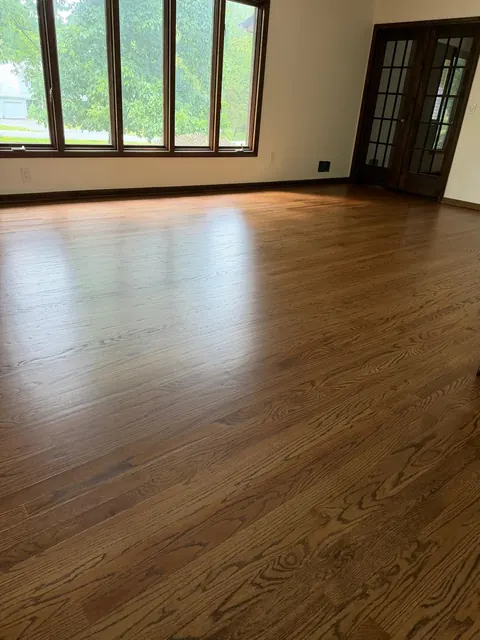 Living room with French doors and a brown stained oak floor