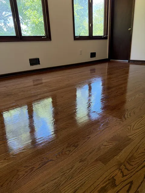 Bedroom with dark trim and a glossy refinished oak floor