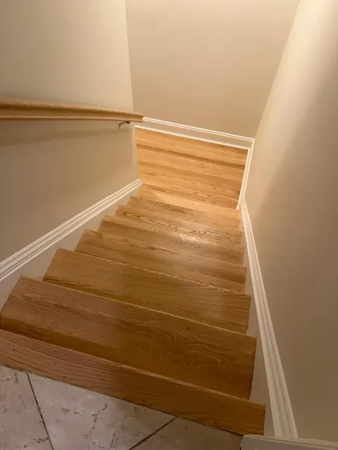 Winder staircase with natural oak treads and white risers