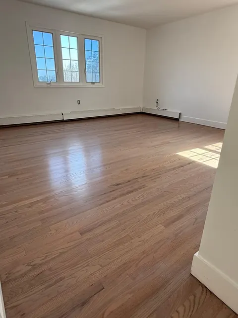 Bedroom with a refinished oak floor, natural tone